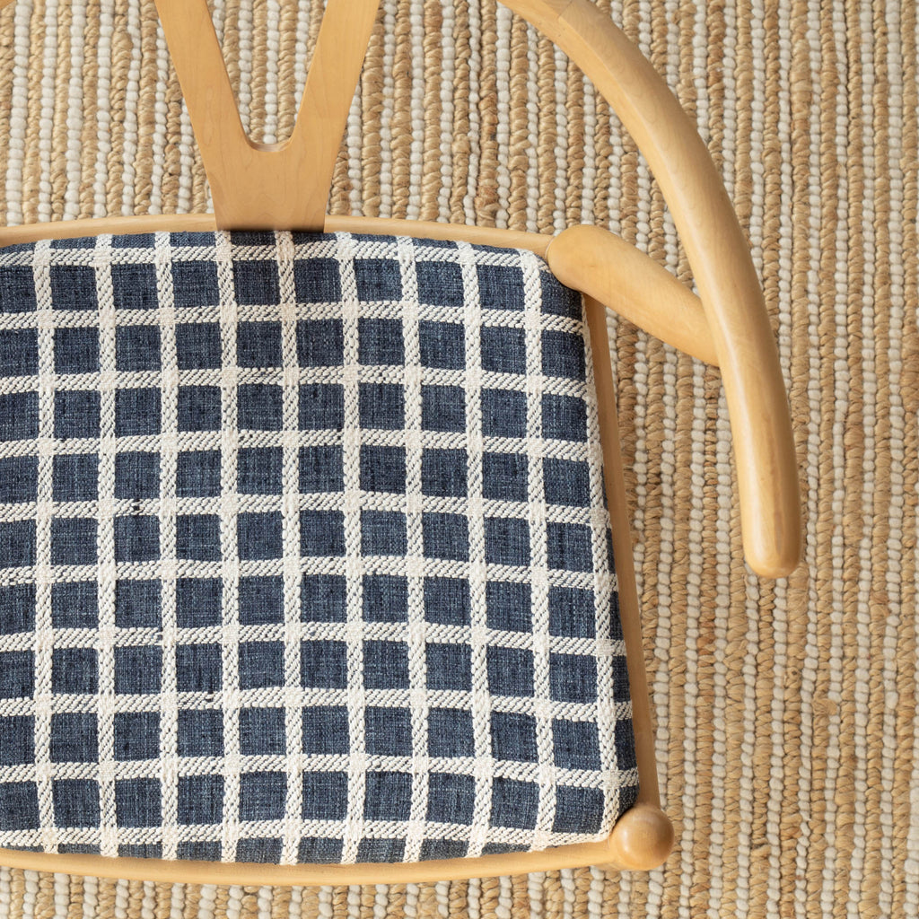 a navy blue and cream plaid check upholstered chair seat 