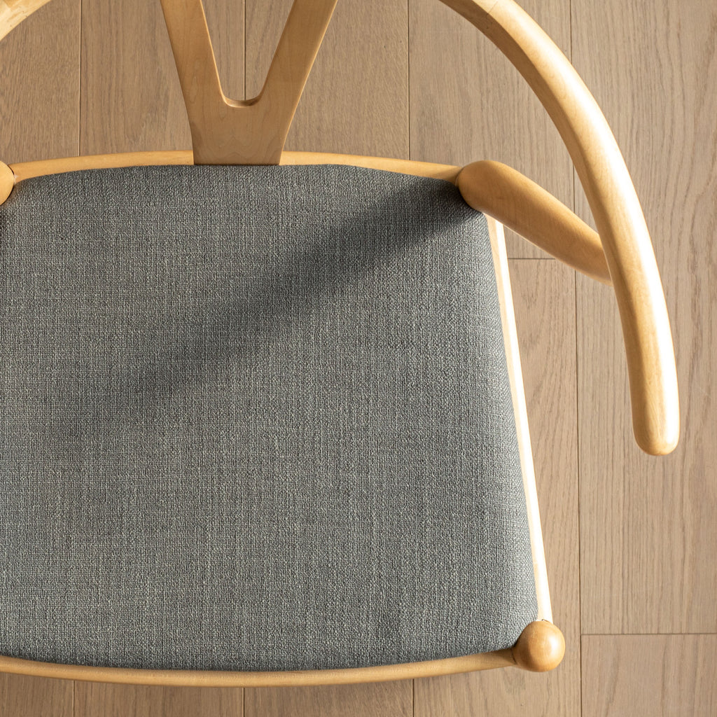 a dark grey upholstered fabric chair seat 