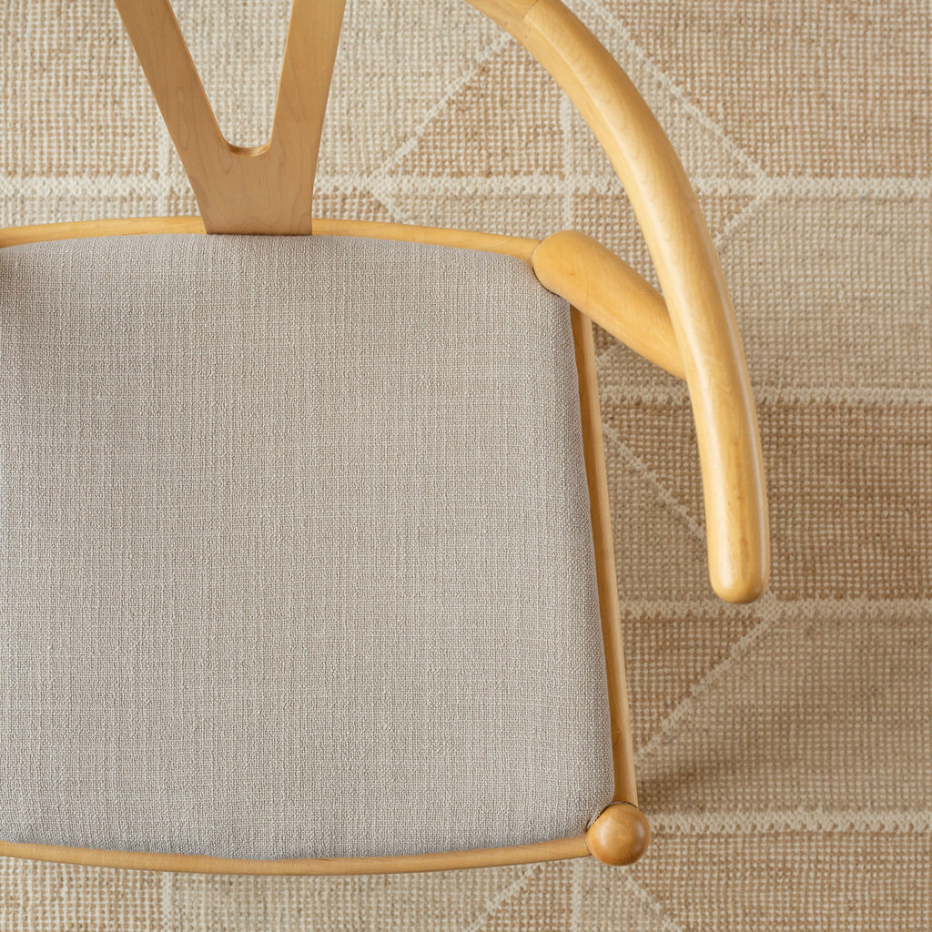Grange Fabric Pumice, an earthy grey high performance upholstery fabric  shown on a chair