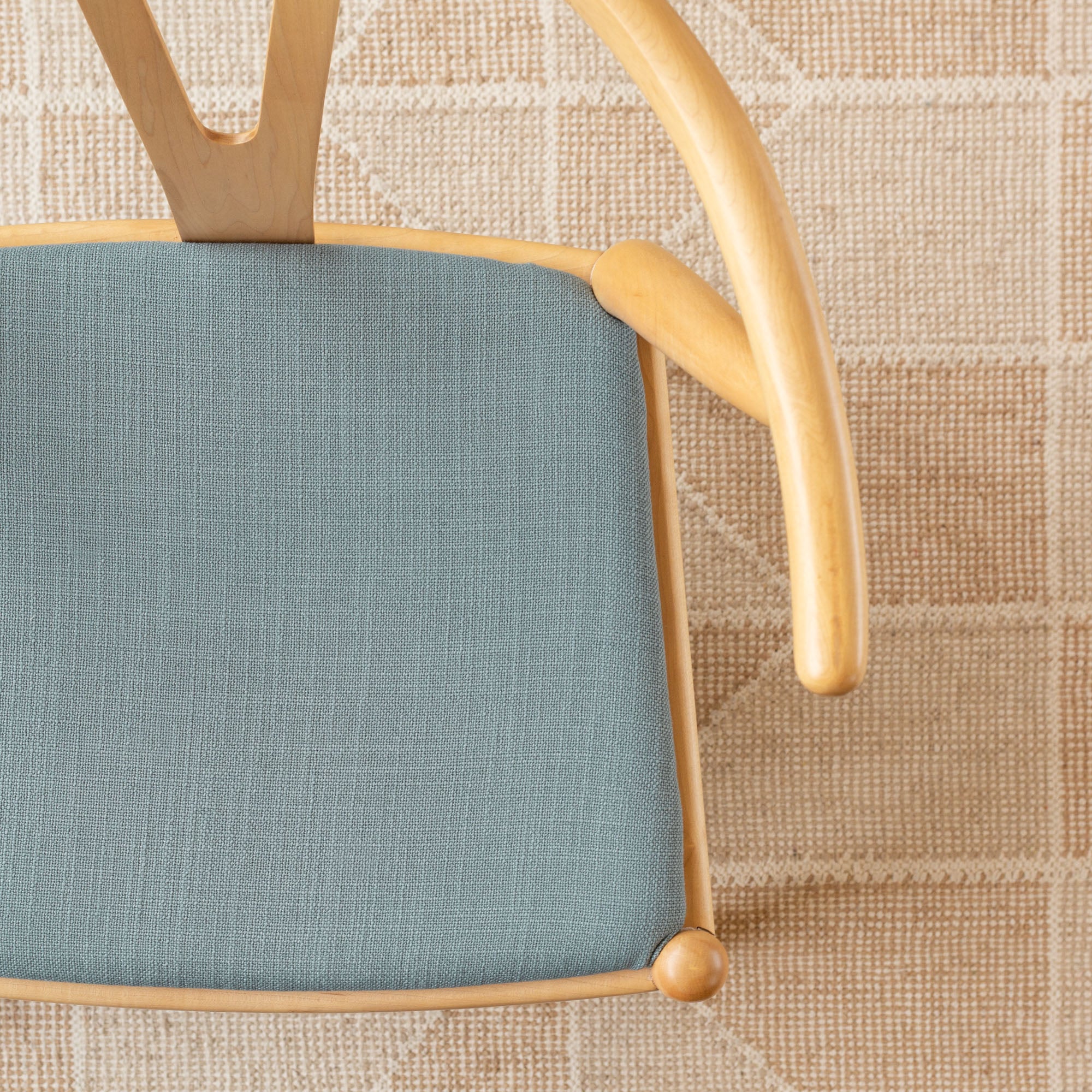 Grange Seaspray, a watery blue high performance upholstery fabric shown on a chair seat