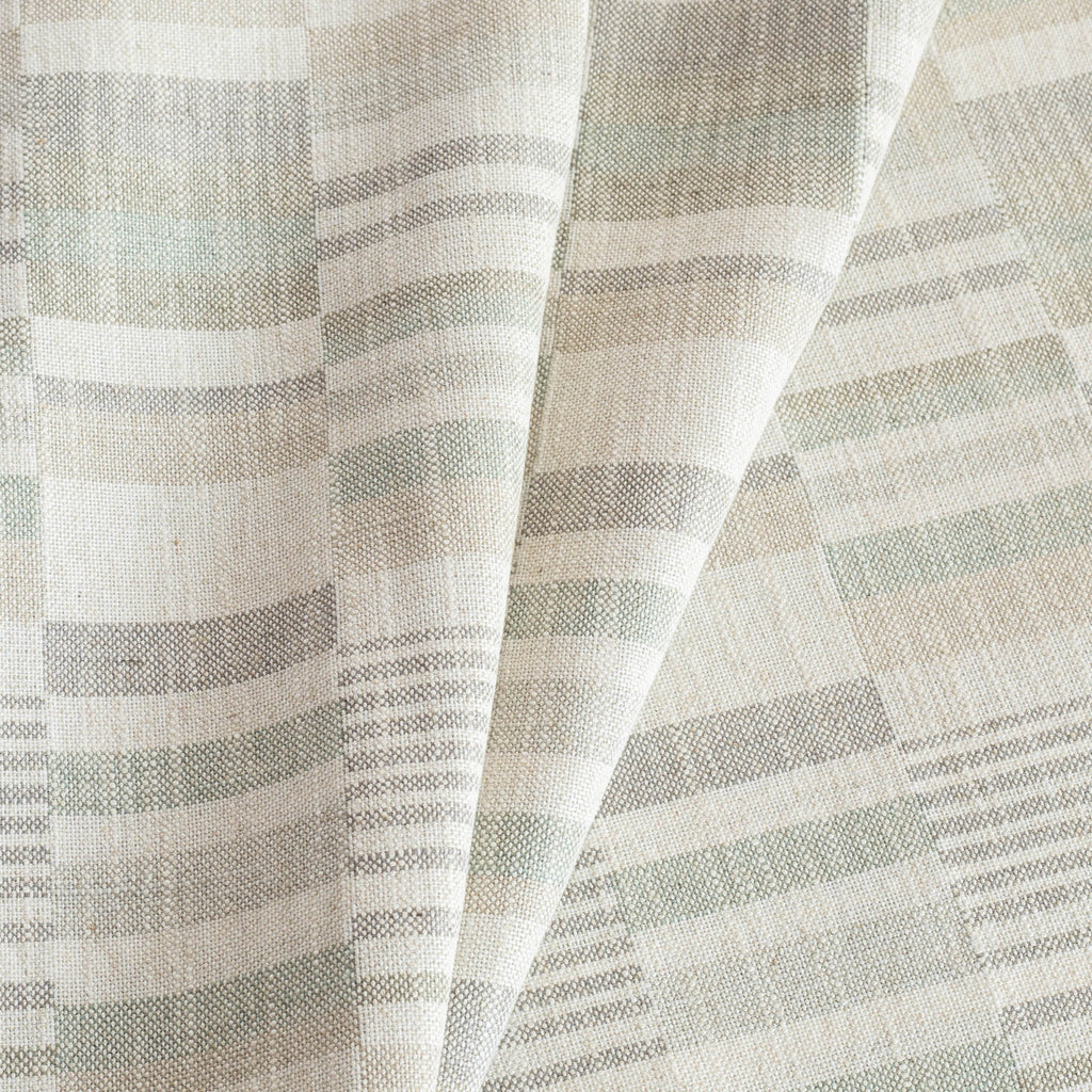 a geometric patchwork patterned home decor fabric in costal watery green, sand, and gray colors