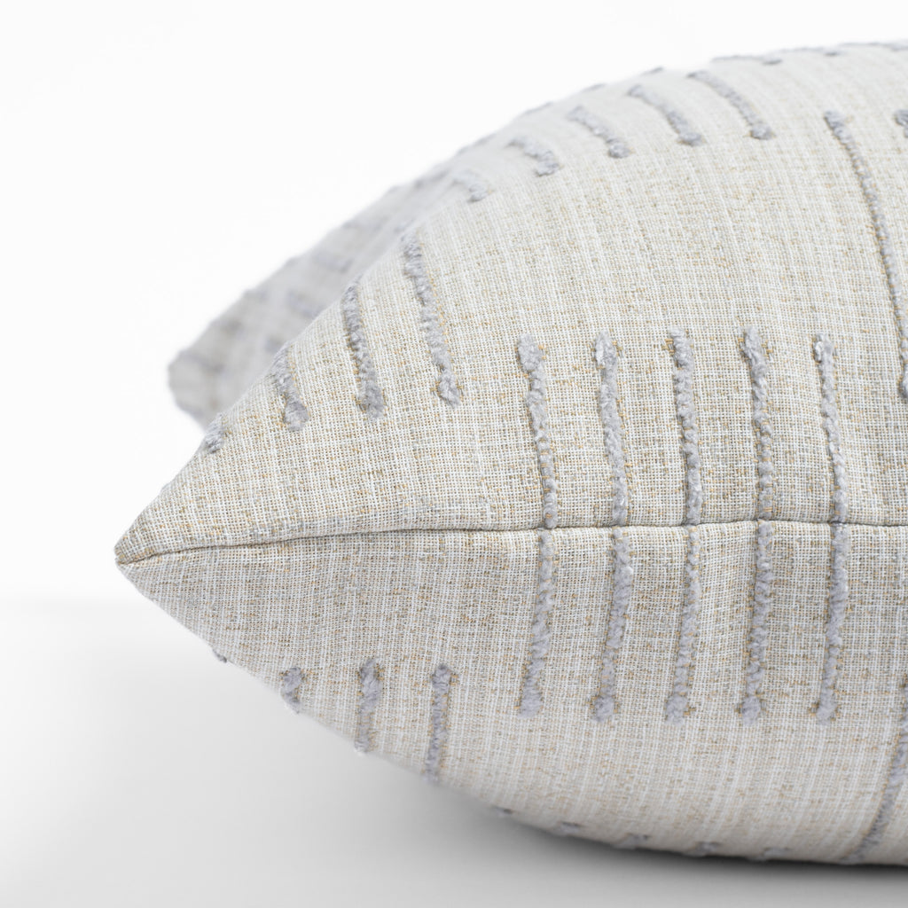 Harlow Desert Sand, a sandy cream pillow with dove gray dashes : close up side view