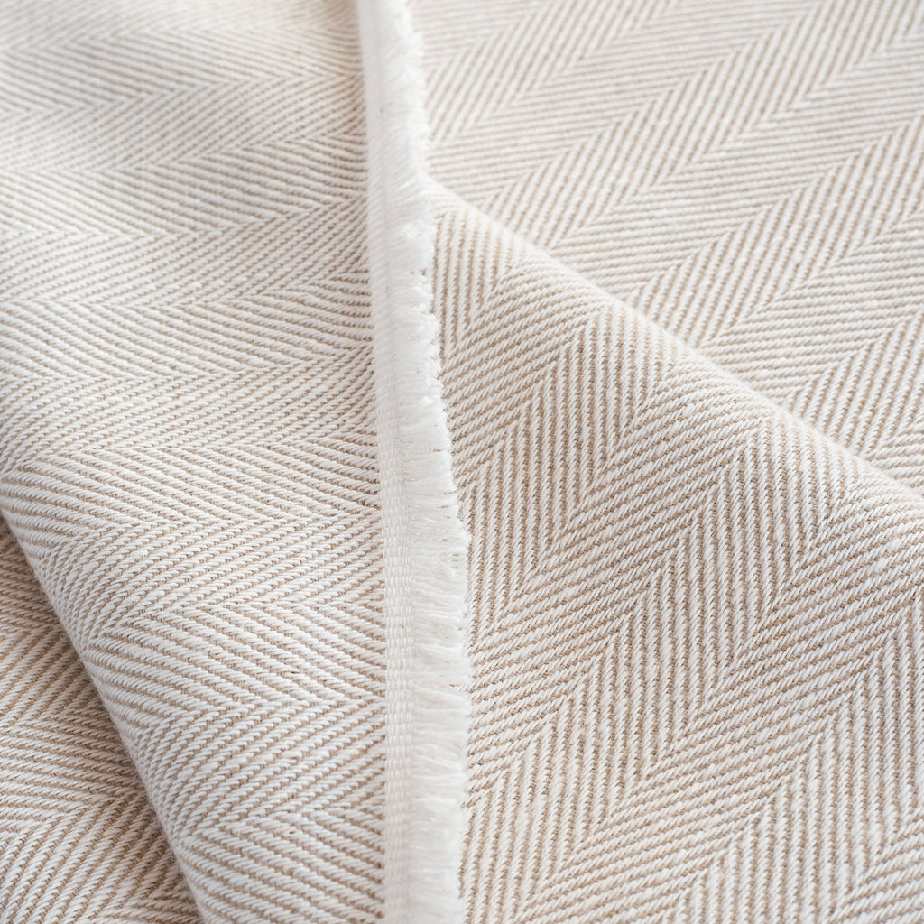 a cream and tan herringbone performance upholstery fabric 