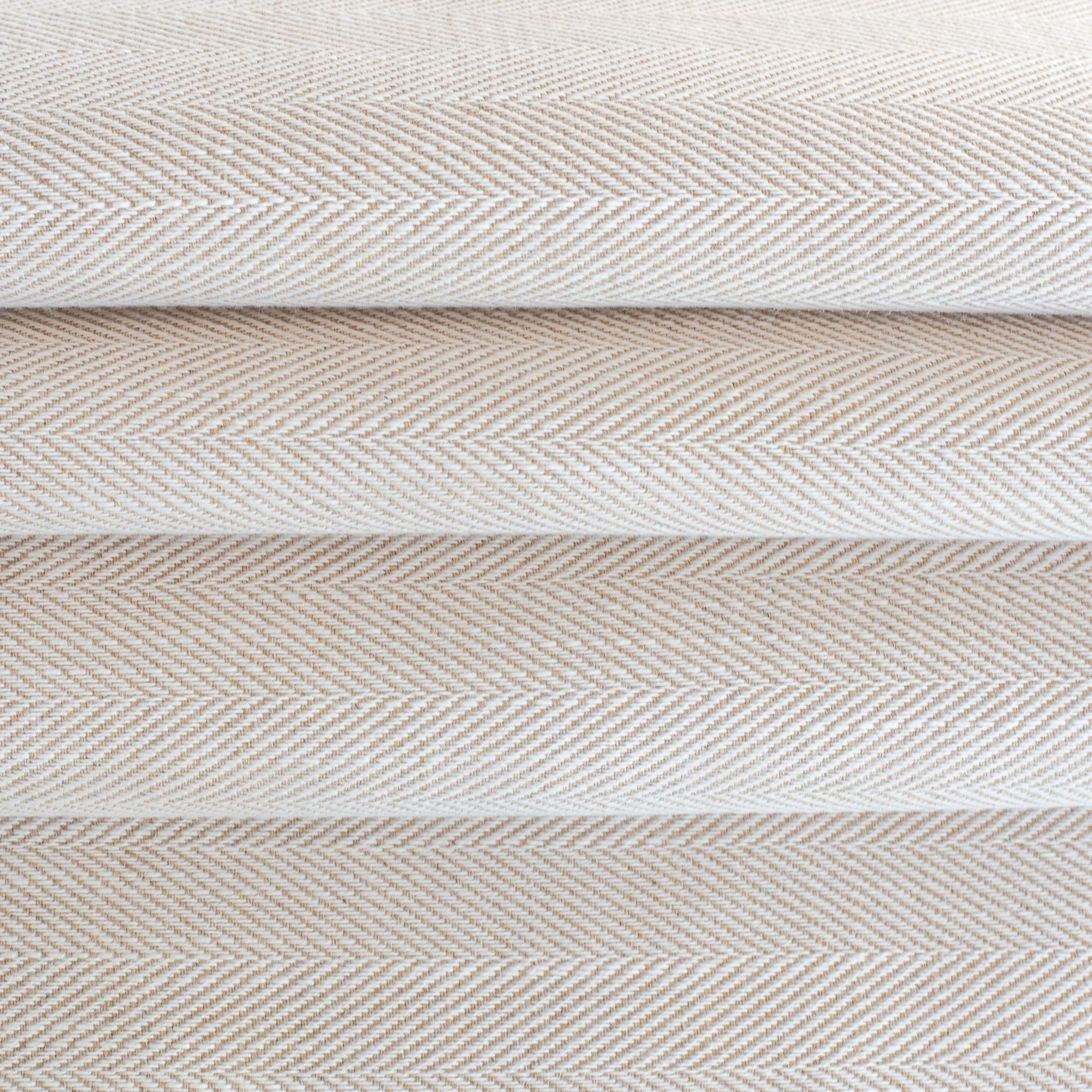 a cream and beige herringbone performance upholstery fabric 