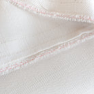 Harris White, a soft white herringbone pattern performance upholstery fabric : detail view