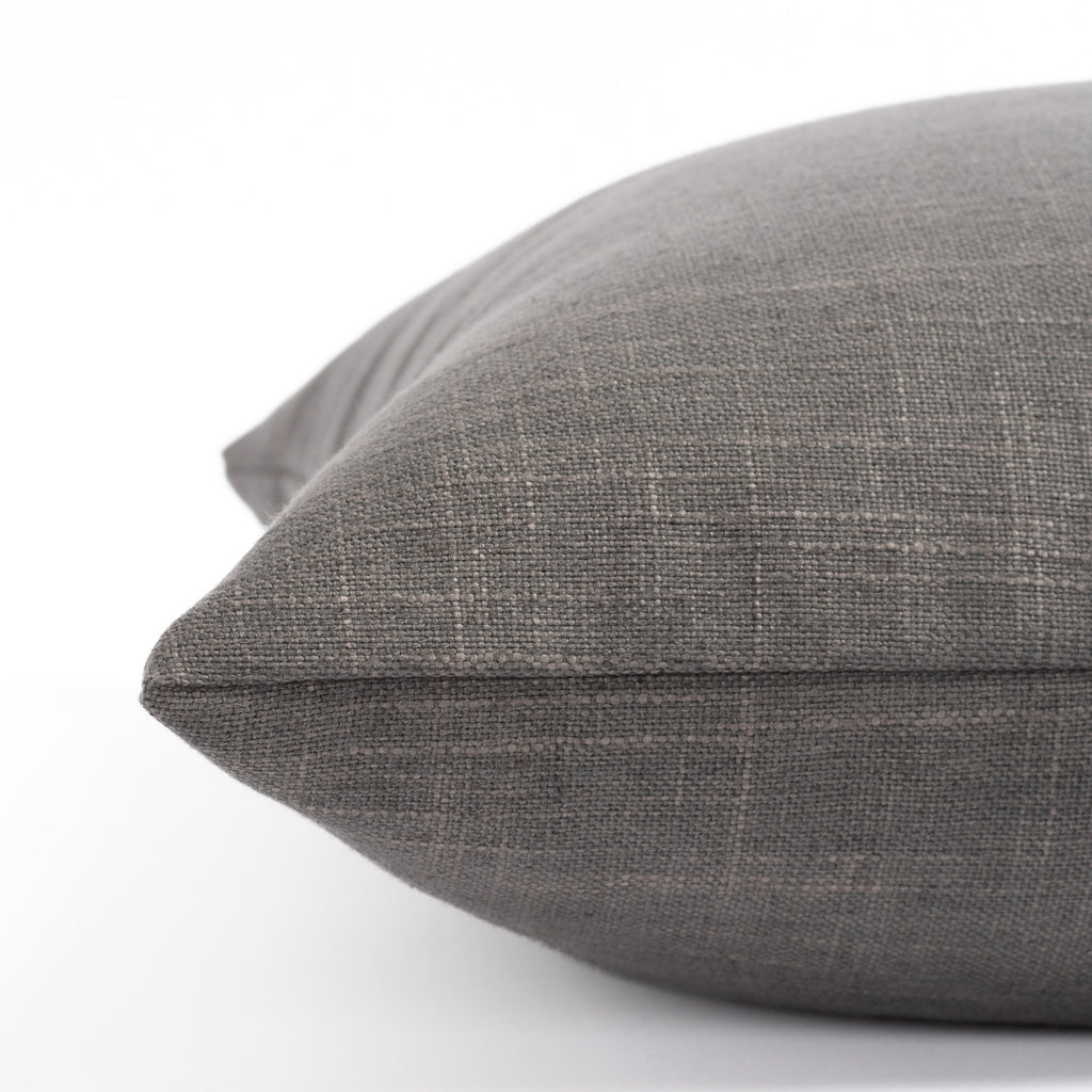 a smoke grey throw pillow : side view