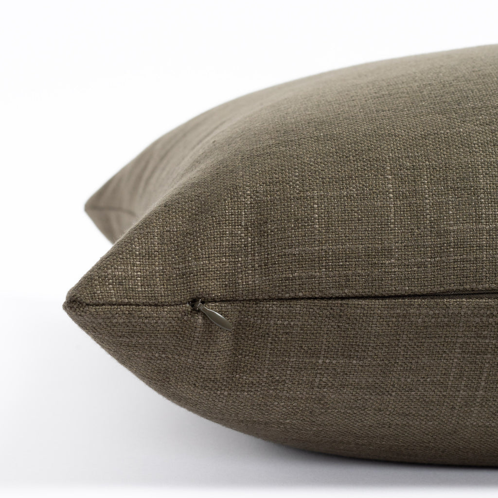 an olive green throw pillow : zipper detail