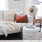 Eclectic modern farmhouse living room with rust, black and white pillows on a sofa