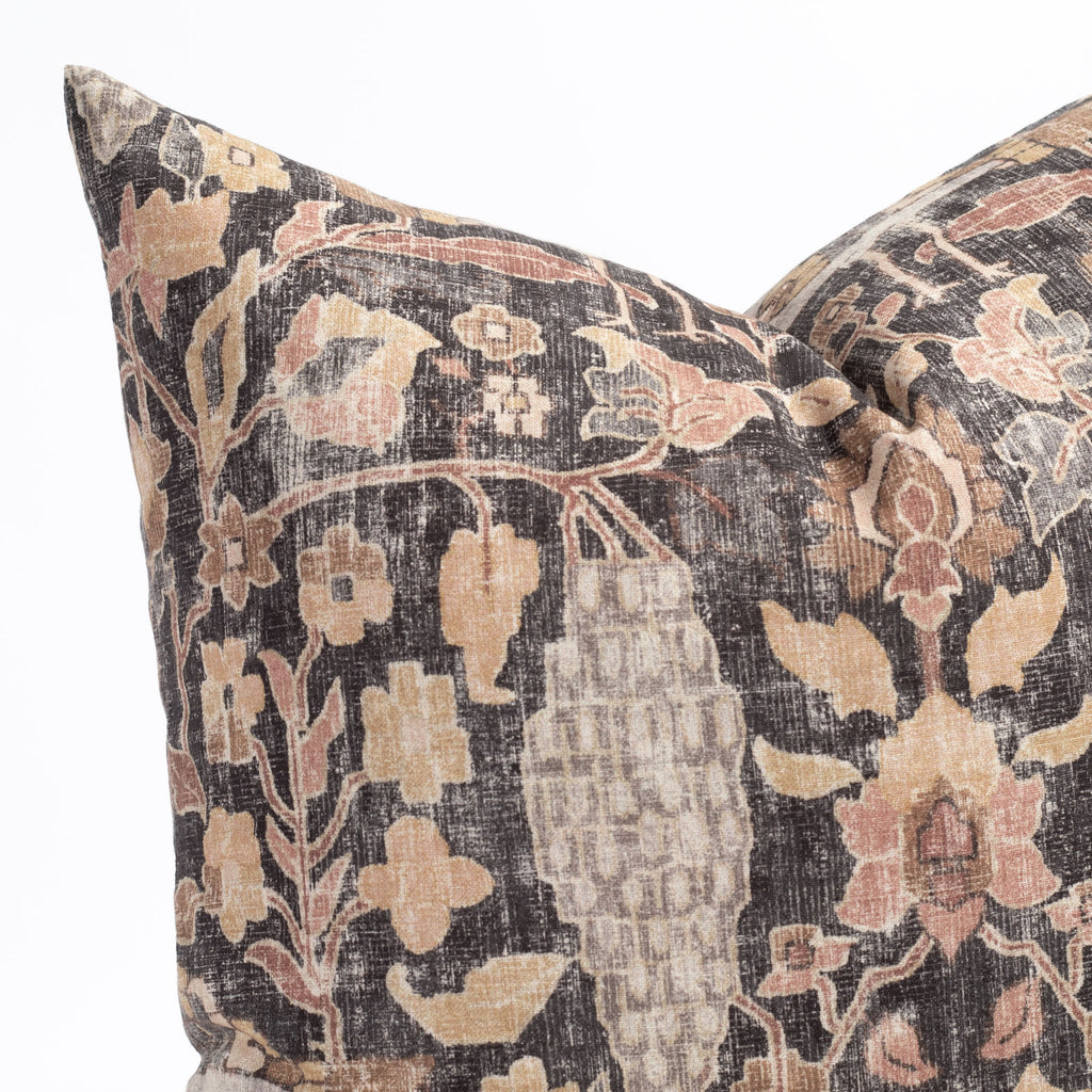 Close up view of Kalida, a faded black and earth toned vintage floral tapestry print decorative pillow