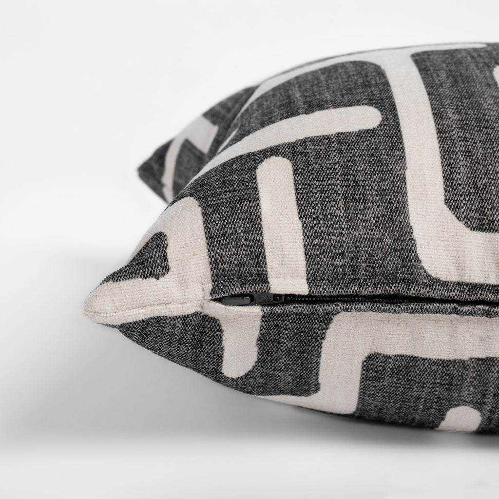 dark gray and beige abstract print lumbar throw pillow zipper detail