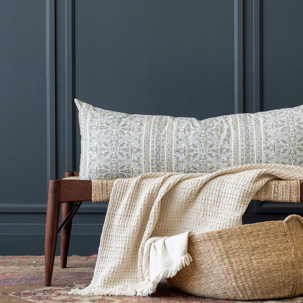 a tan and light blue-gray motif intricate block print bolster pillow from Tonic Living