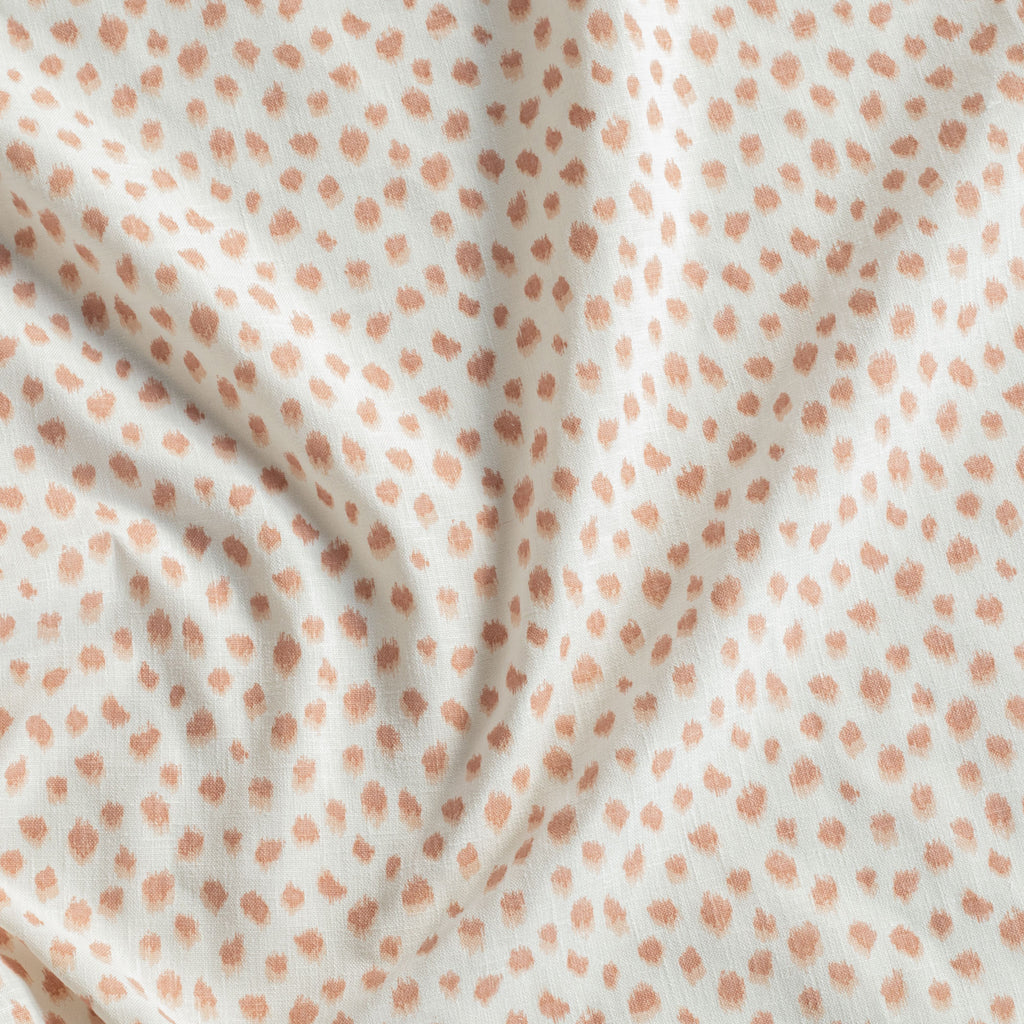 a white and pink inky polka dot designer print fabric