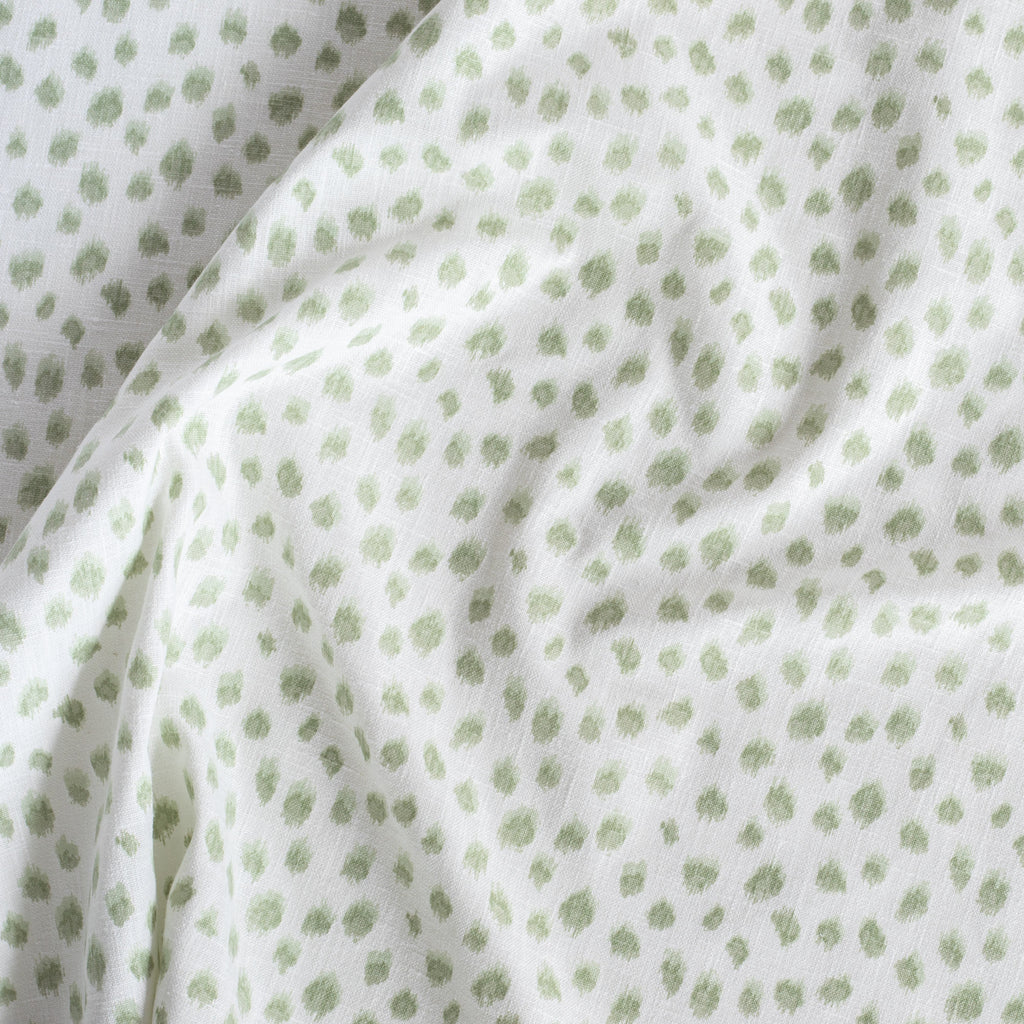 Mara Spot Sage Green, a white and green inky dot print fabric from Tonic Living