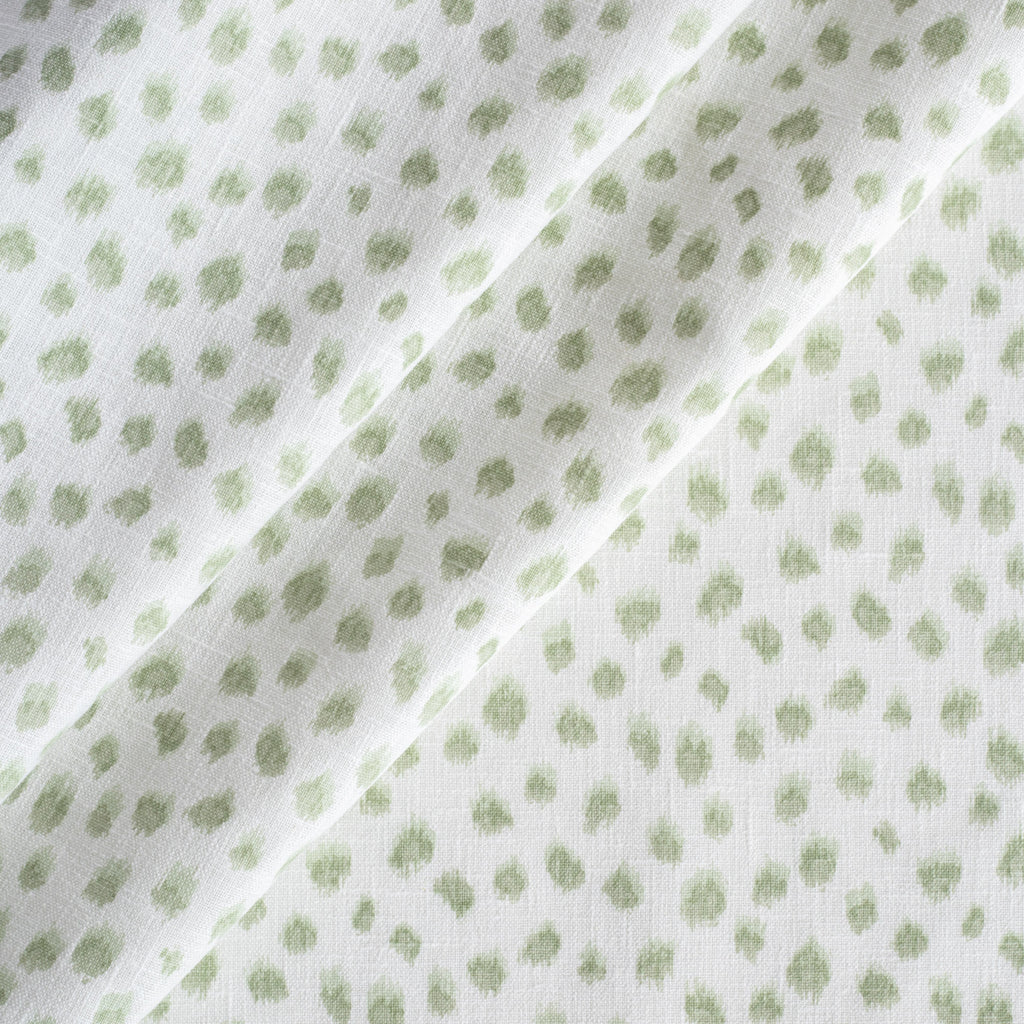 a white and green inky dot print fabric