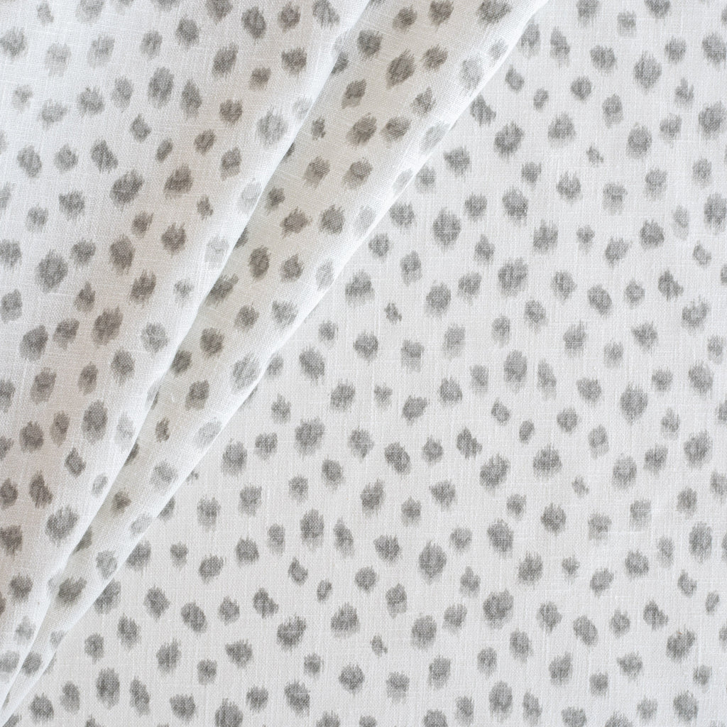 a white and silver grey inky dot print fabric
