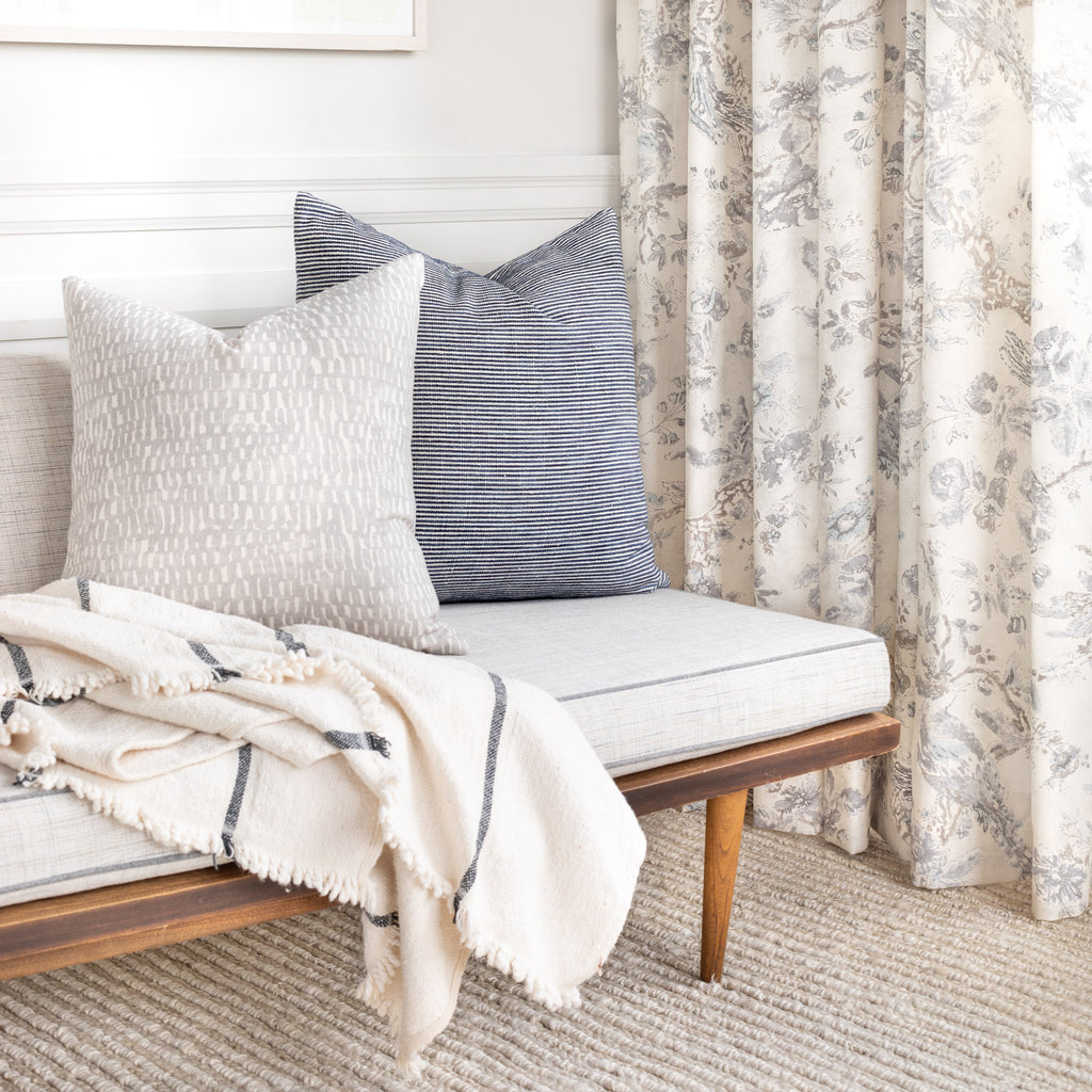 Grey and blue living room vignette: Marklin pillow and Avareno pillow on sofa with Collette Flint drapes