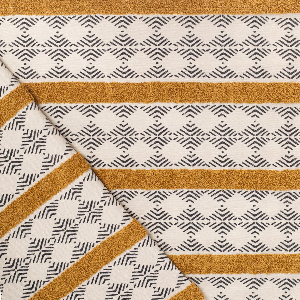 Mirza Stripe, a black and ivory geometric print with a golden embroidered stripe fabric from Tonic Living