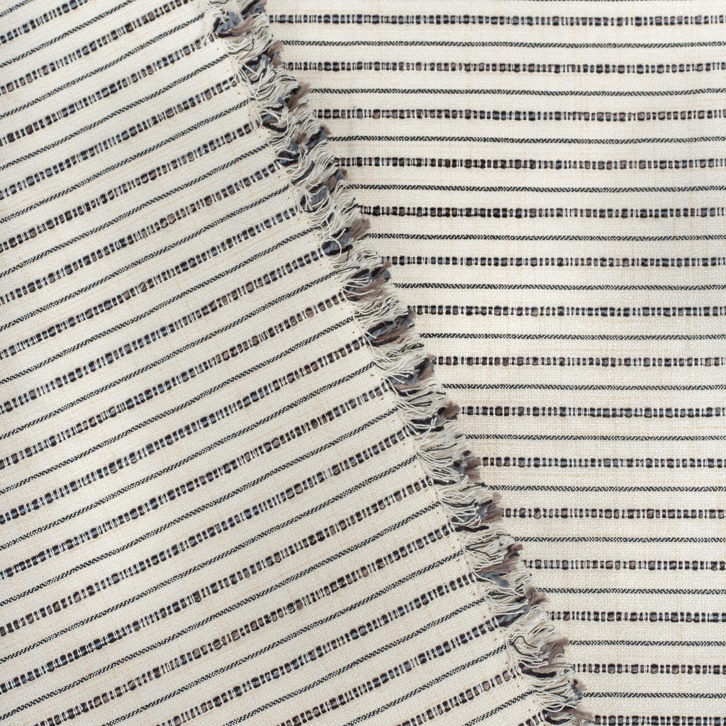Misto Stripe Cream and Black, a cream and black striped Crypton home performance fabric : view with selvage edge 