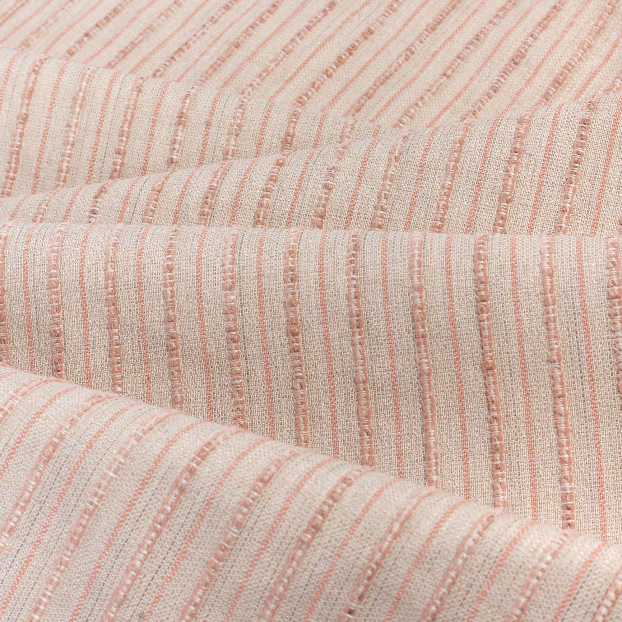 Misto Coral Blush, a light pink and light tan horizontal striped Crypton Home performance fabric : soft folds view
