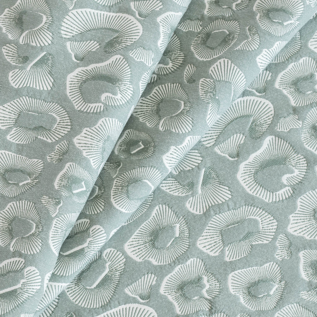 an ocean blue green and white abstract pattern upholstery fabric