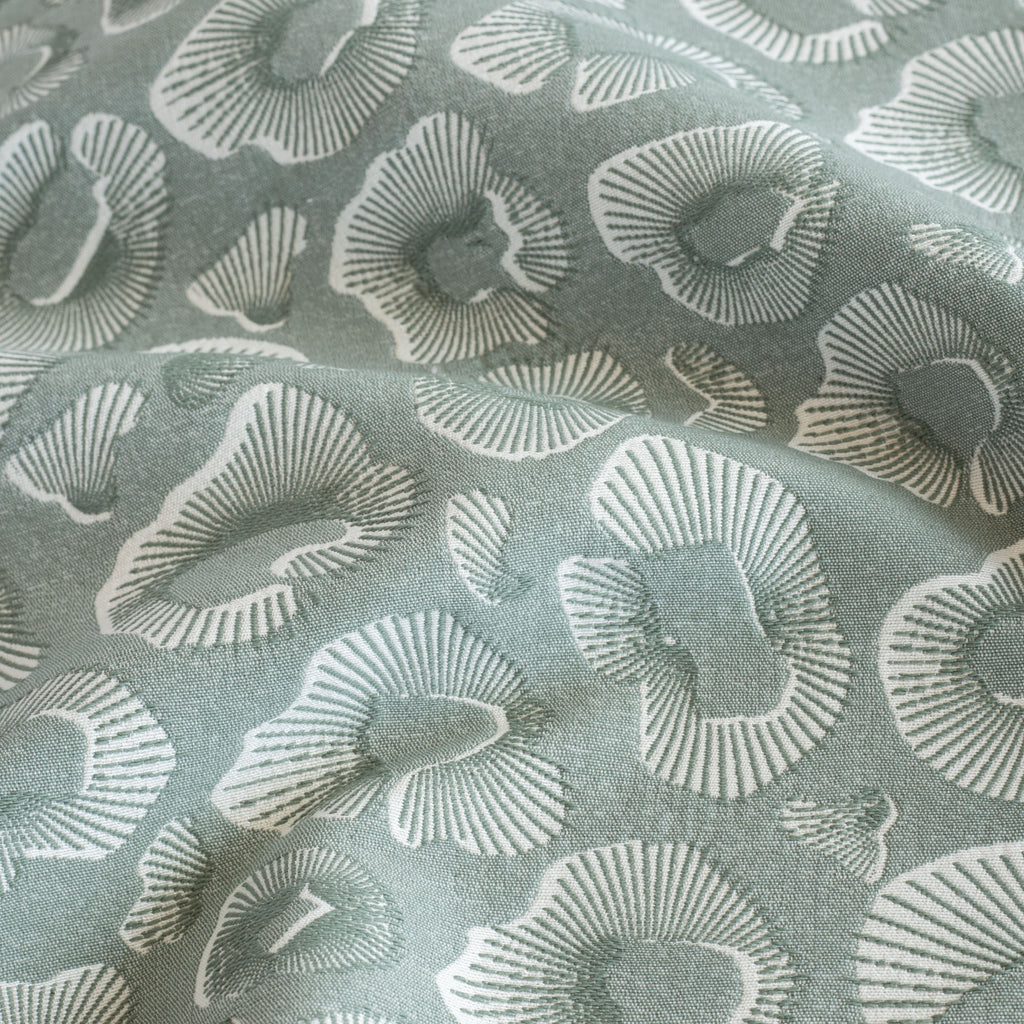a blue green and white abstract ocean pattern home decor fabric