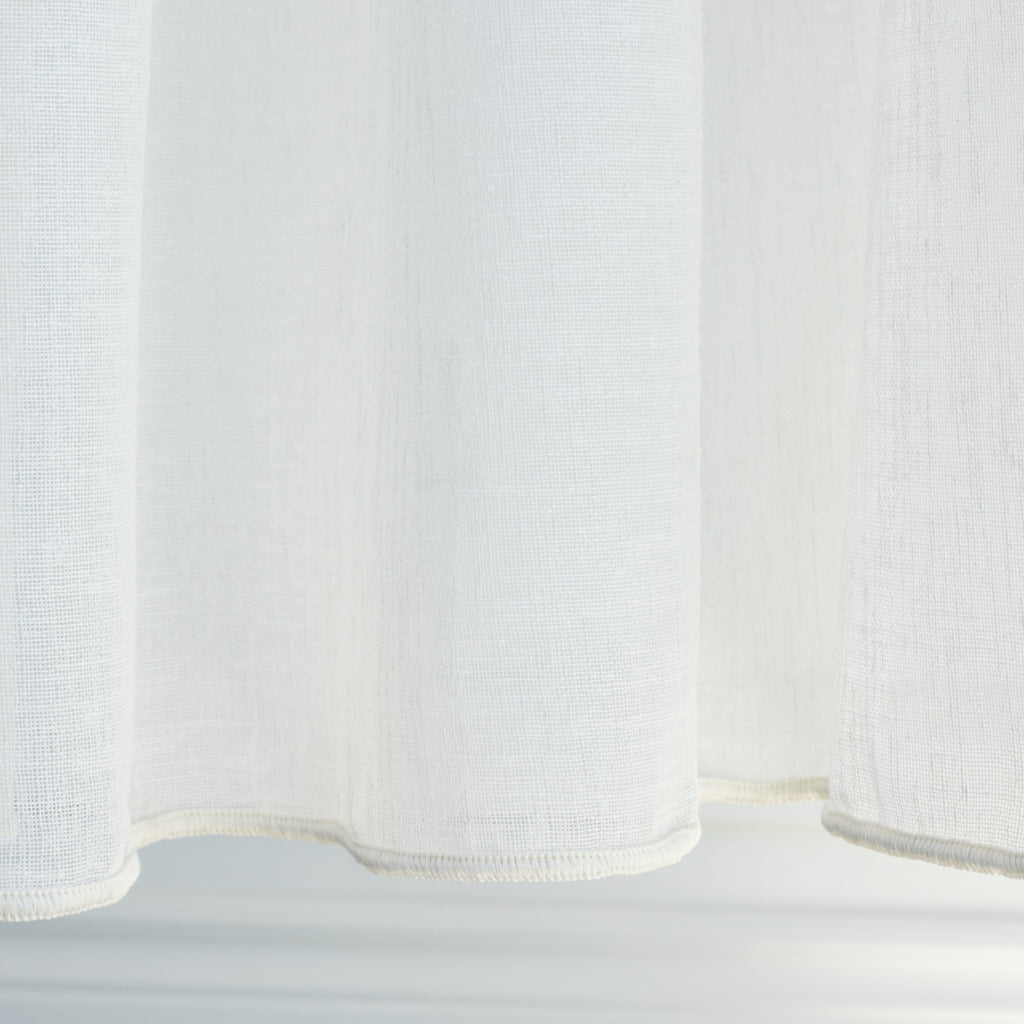 an oyster white sheer drapery fabric - weight bottom edge