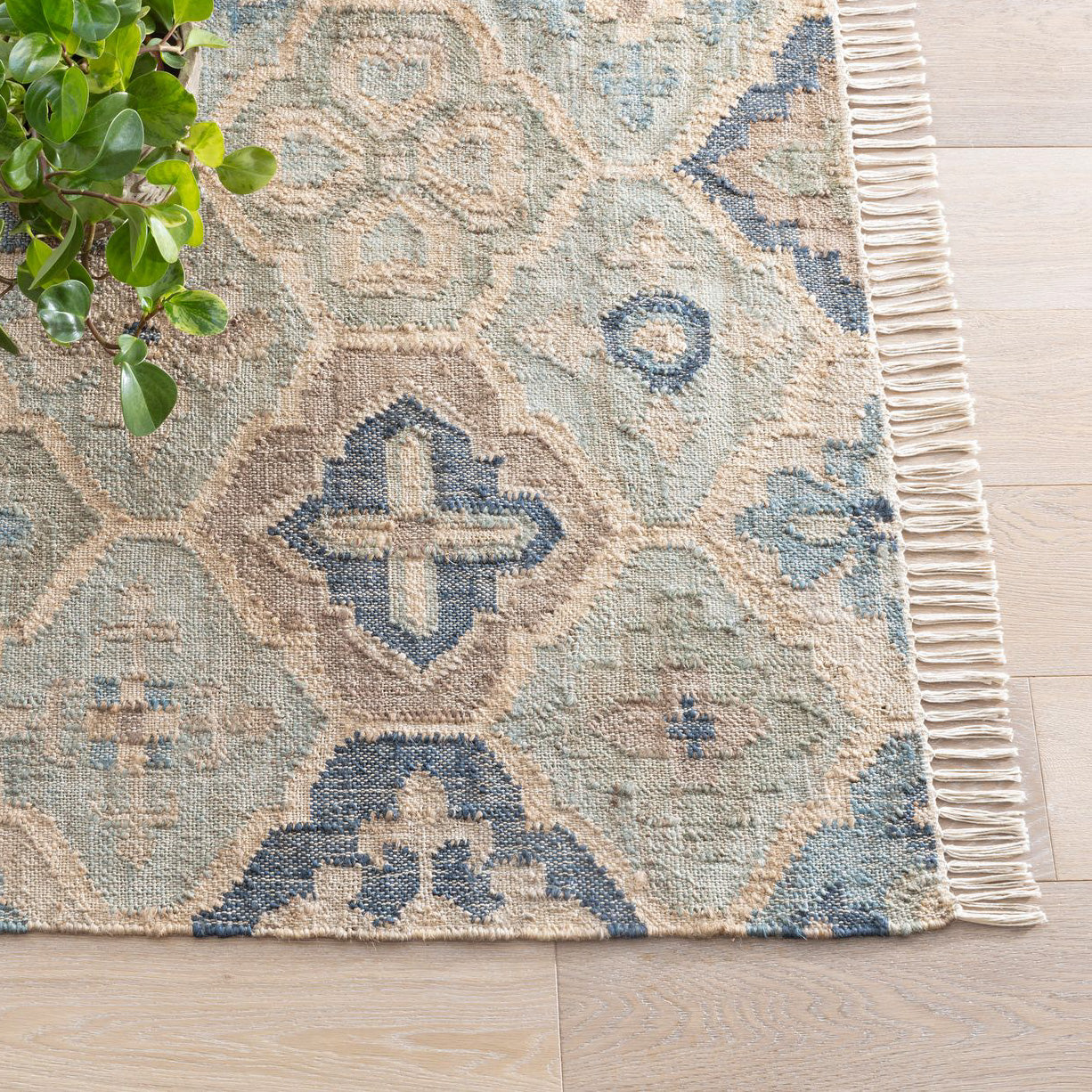 a blue and neutral medallion pattern jute rug
