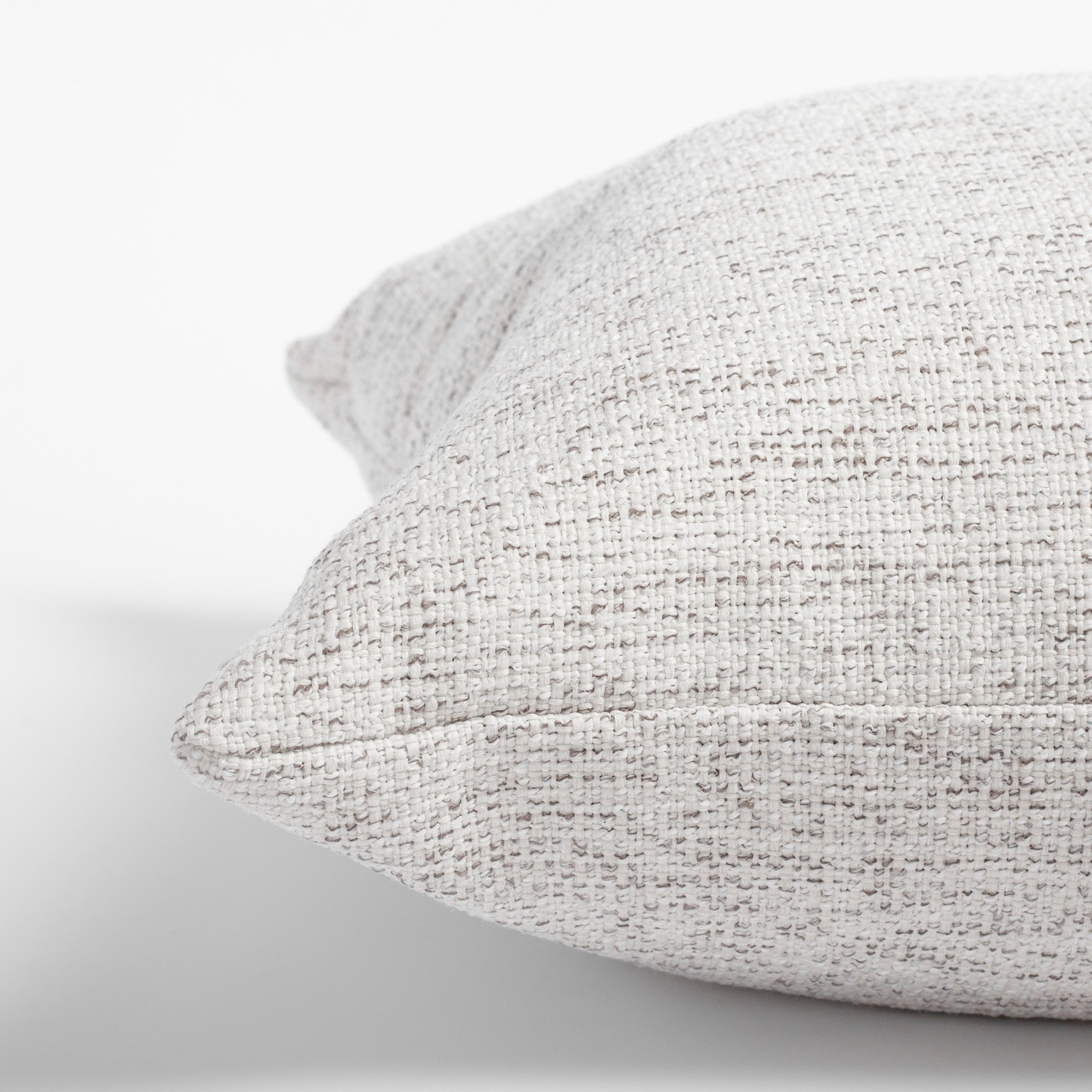 Preston Birch, a heathered cream and light gray indoor outdoor pillow: close up view
