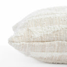  a cream textured abstract patterned lumbar throw pillow : close up side view