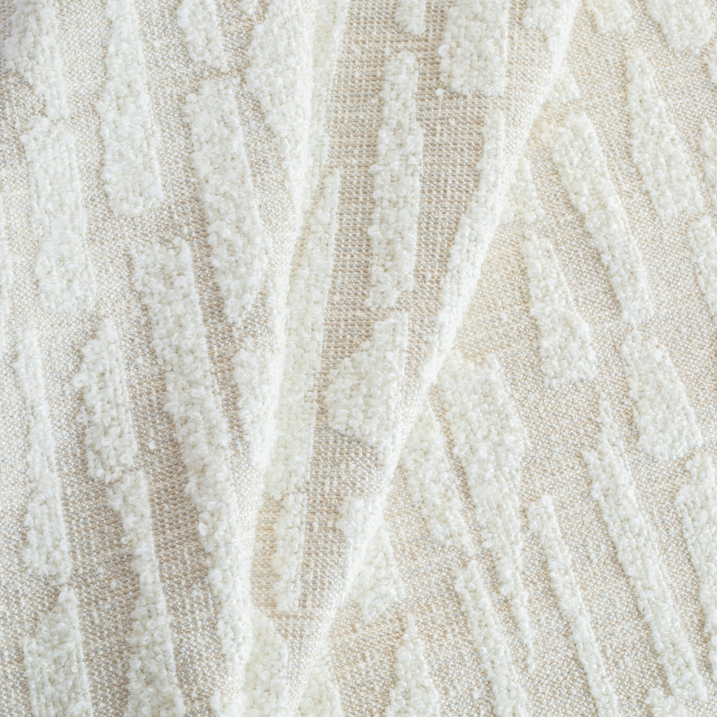 a cream, abstract patterned, boucle textured Tonic Living upholstery fabric