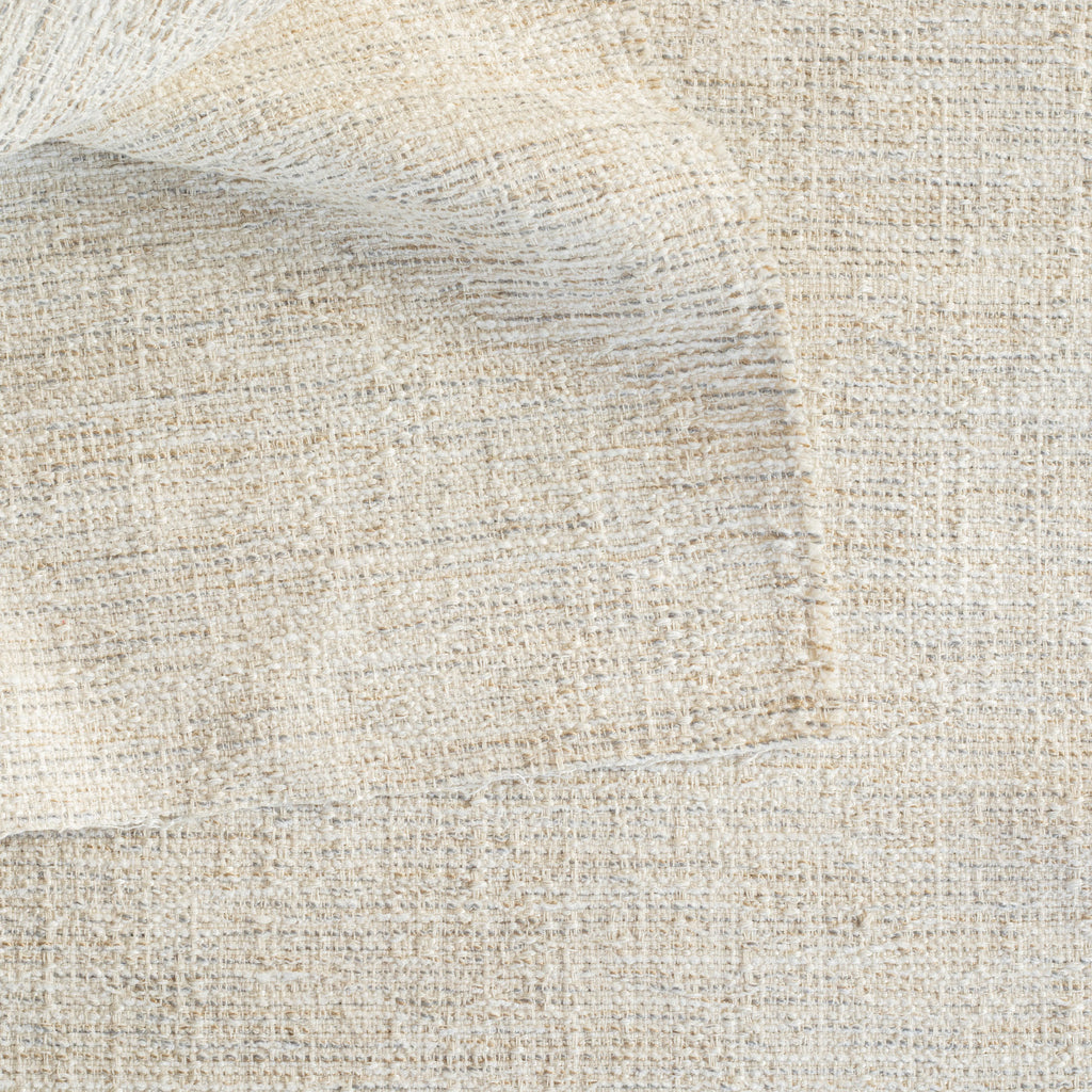 a beige textured woven upholstery fabric 