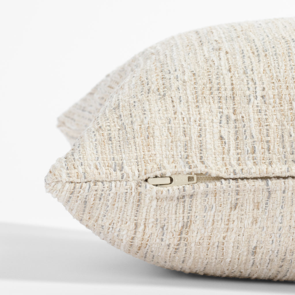 a cream lumbar throw pillow : zipper detail