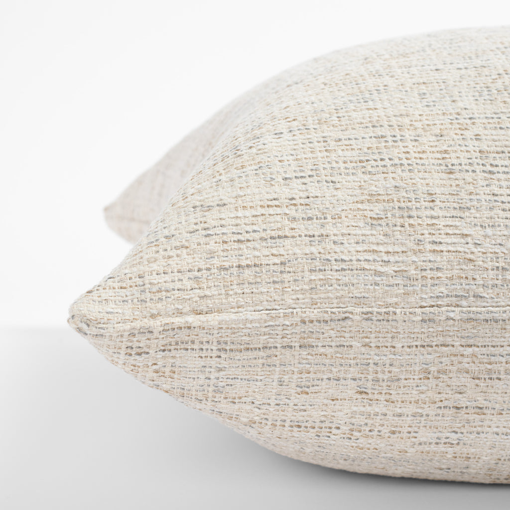 a cream beige textured throw pillow - close up side view
