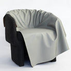 a gray vinyl upholstery fabric draped on a chair