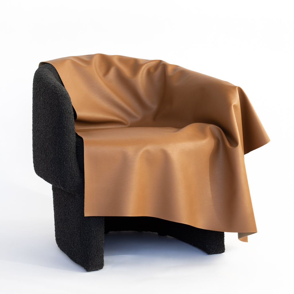 saddle brown faux leather vinyl fabric draped on a chair