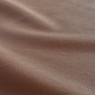 a deep brown vinyl faux leather performance upholstery fabric : close up view 2