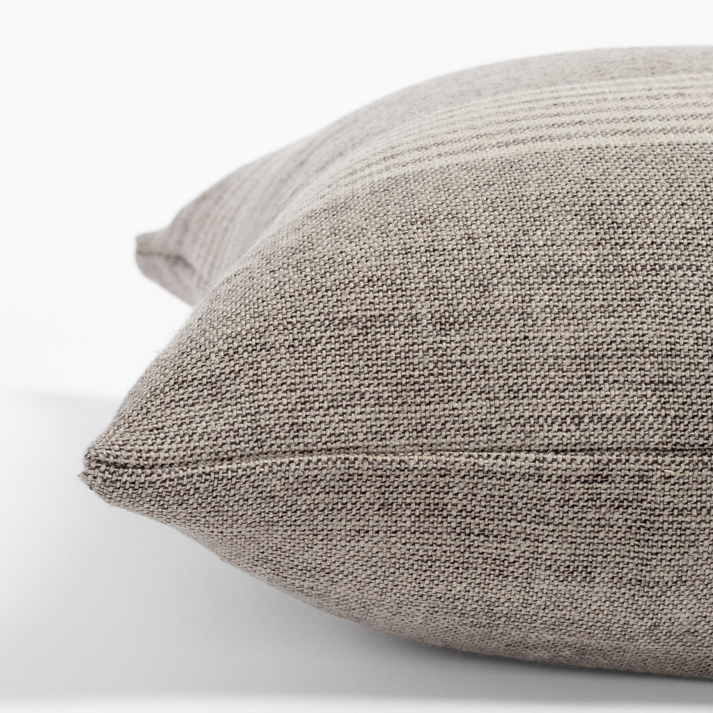 Stockton Stripe Graphite, a linen throw pillow, in shades of natural tan and faded black from Tonic Living : seam detail view