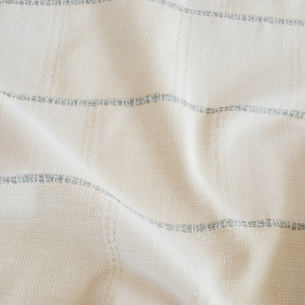a cream and white patchwork pattern with a a chunky light blue horizontal stripe home decor