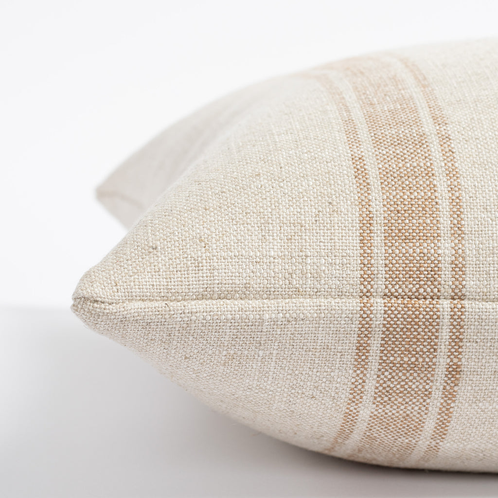 a cream and faded rust stripe throw pillow : close up side view