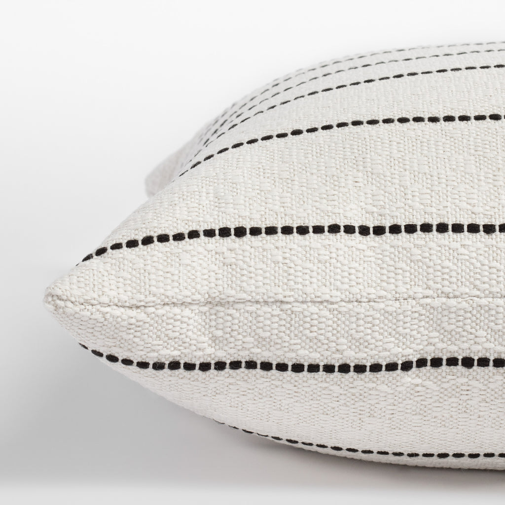 Toulouse Onyx, a black and white dotted stripe pillow: close up side view
