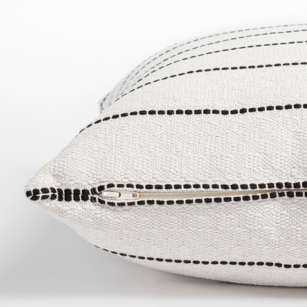 Toulouse Onyx, a black and white dotted stripe pillow: close up zipper view