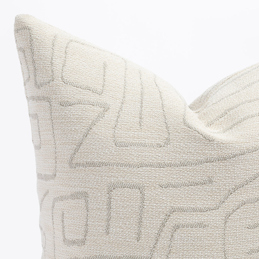 a cream and grey abstract line patterned pillow : close up view