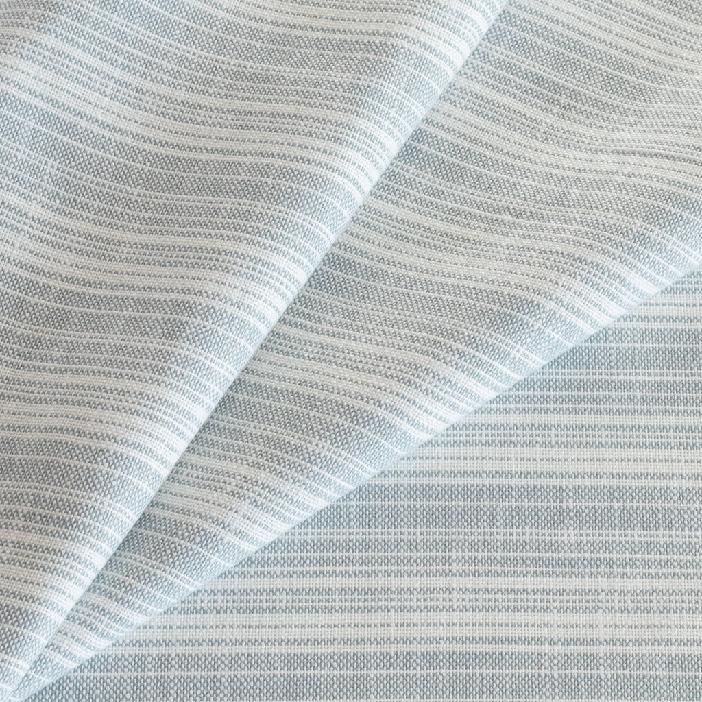 Trouville Sky Blue and white variegated stripe patterned indoor outdoor fabric from Tonic Living