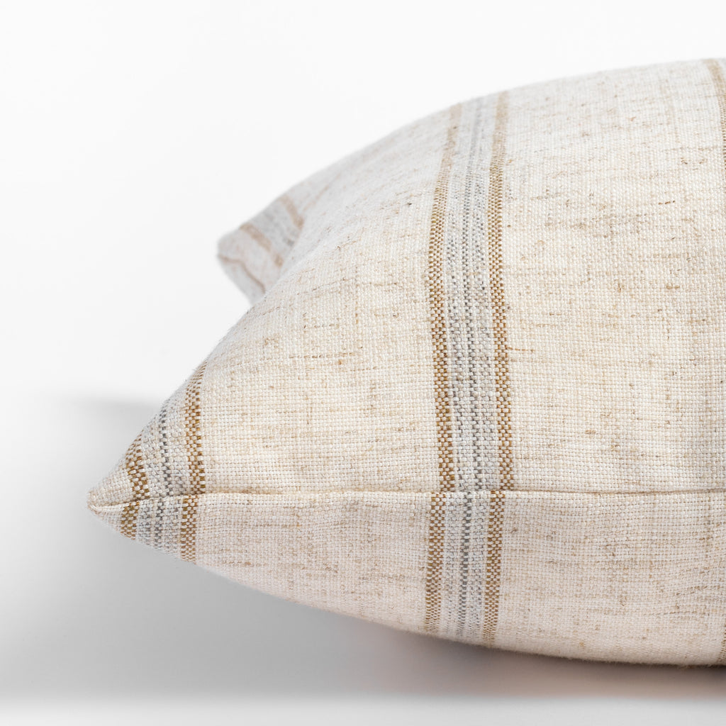 Yarmouth Stripe Sandstone, a beige lumbar pillow with golden sand and gray vertical stripes : close up side view