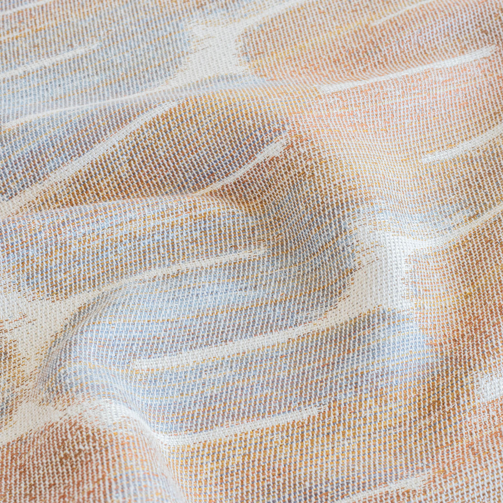 a terracotta orange, blue and cream graphic tubular patterned upholstery fabric