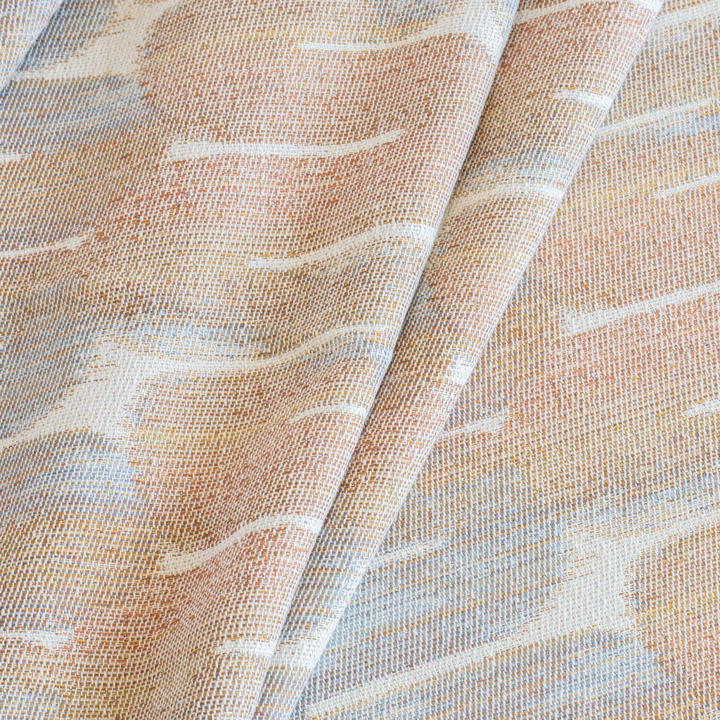 a terracotta orange, blue and cream painterly patterned designer fabric