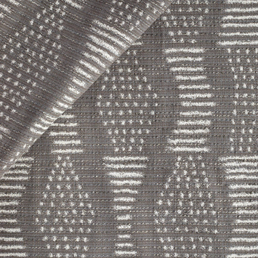 Zipporah Nickel, a dark gray upholstery fabric with cream dot dash motifs from Tonic Living